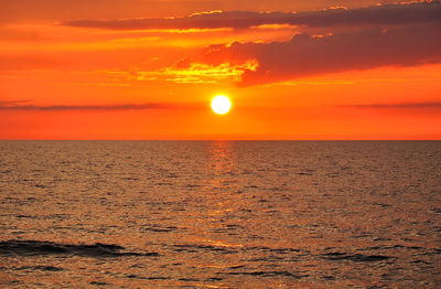 Scenic view of sea against romantic sky at sunset