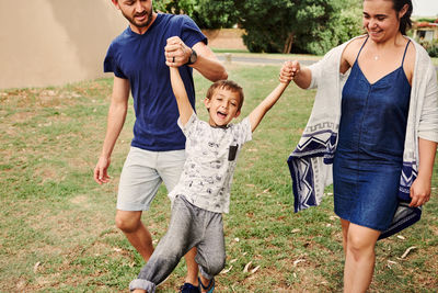 Father and mother holding son