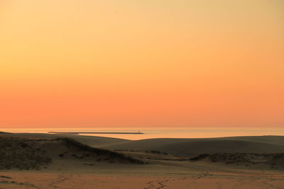 Scenic view of sea against clear sky during sunset