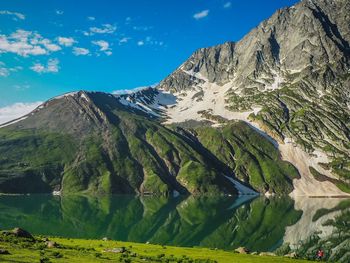 Scenic view of mountains against blue sky