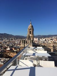 High angle view of city buildings against clear sky