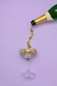 Abstract pouring champagne wine in glass from bottle