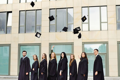 Low angle view of business people standing against wall