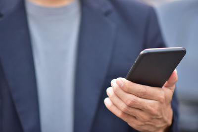 Close-up of man using mobile phone
