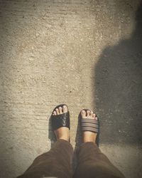 Low section of woman standing on concrete floor