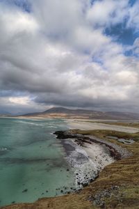 View of beach against cloudy sky