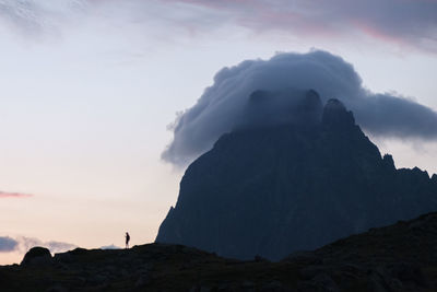 Scenic view of silhouette rocks against sky during sunset