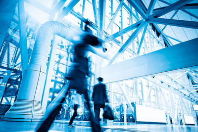 Low angle view of people walking in modern building