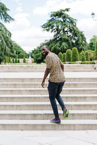 Positive afro american stylish man in european city