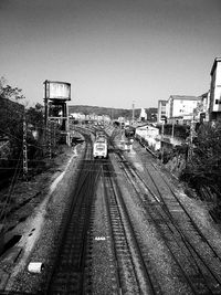 High angle view of railroad tracks in city against clear sky