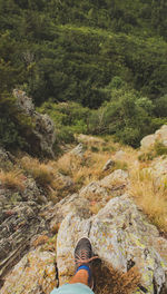 Low section of man standing cliff