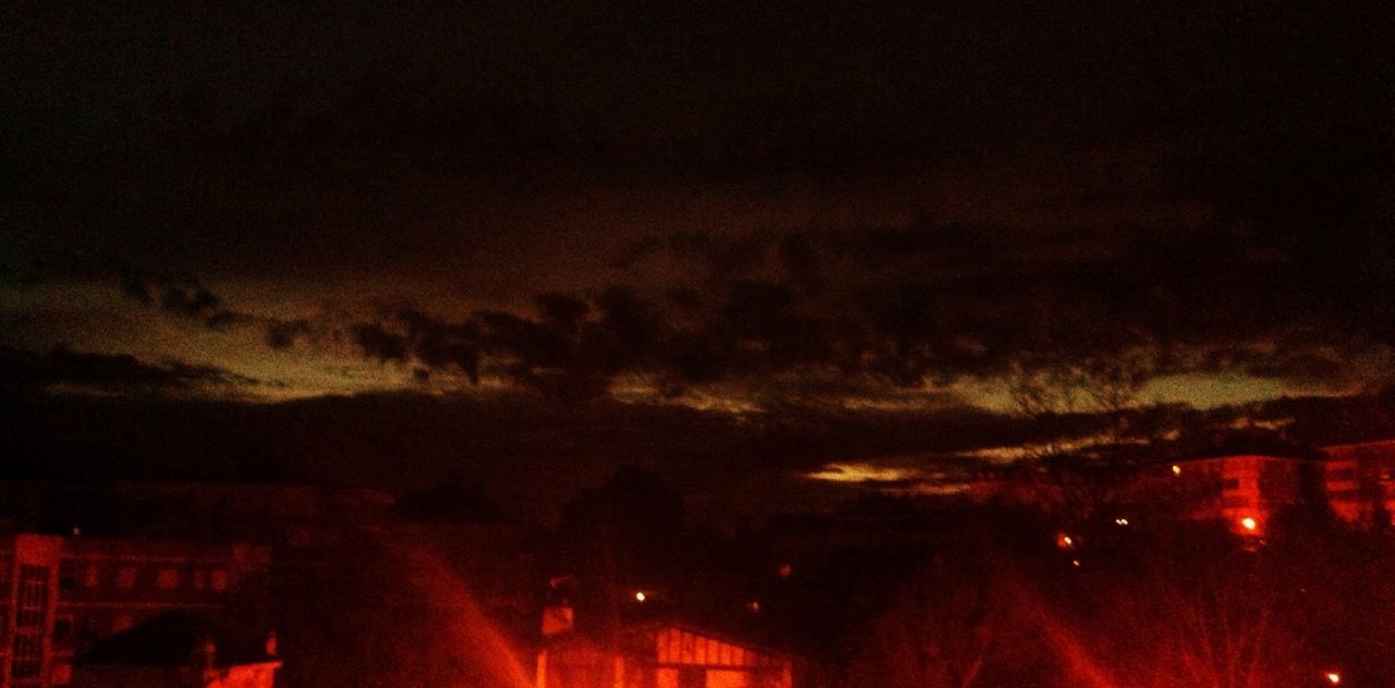 illuminated, night, sky, building exterior, dusk, built structure, architecture, city, cloud - sky, transportation, weather, road, outdoors, car, high angle view, street, no people, tree, light - natural phenomenon, nature