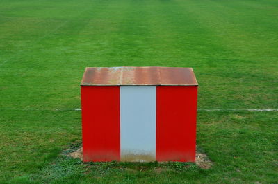 Close-up of red umbrella on field