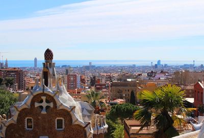 High angle view of trees and buildings against sky park guell