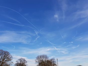 Low angle view of vapor trails in sky