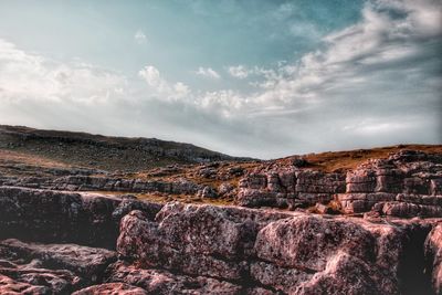 Scenic view of landscape against cloudy sky