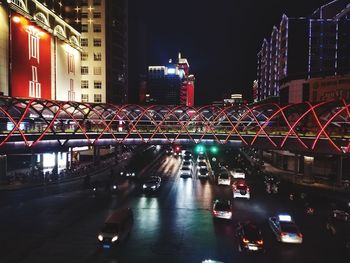 Illuminated city street and buildings at night