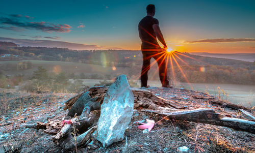 Rear view of man on mountain during sunset