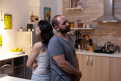 Young couple standing at home