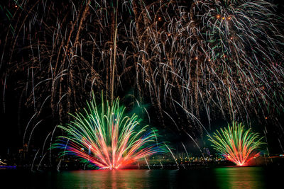 Low angle view of firework display at night