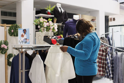 Rear view of woman holding shopping bags