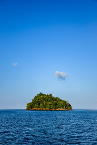 Scenic view of sea against blue sky