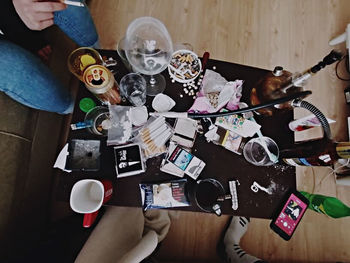 Directly above shot of people holding glass on table