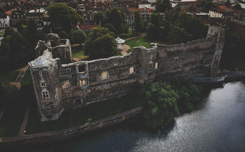 High angle view of old building by river in city