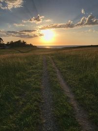 Scenic view of land against sky during sunset