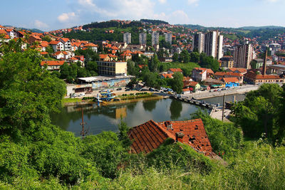 High angle view of river and cityscape against sky