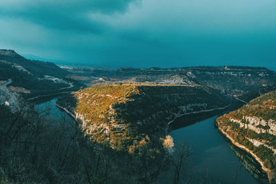 High angle view of river amidst trees against sky