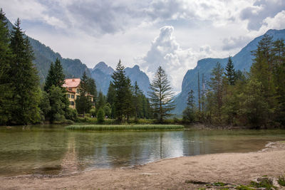 Scenic view of lake by trees against sky