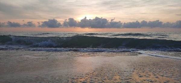 Scenic view of beach against sky during sunset