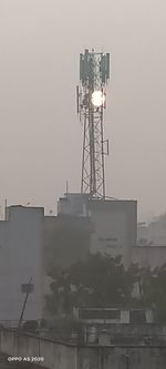 Low angle view of illuminated tower against sky at dusk