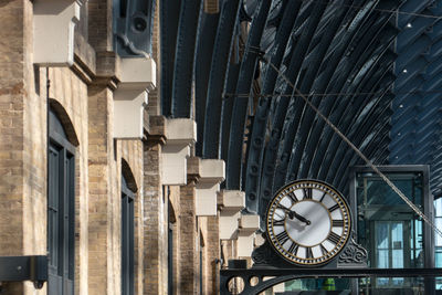 Close-up of clock against built structure