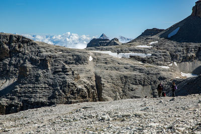 Panoramic view of people on mountain range against sky