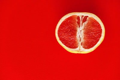 Close-up of strawberry against red background