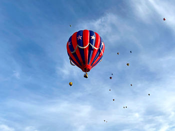 Low angle view of hot air balloons flying in sky