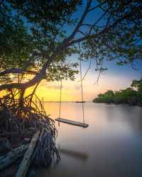 Scenic view of lake against sky at sunset