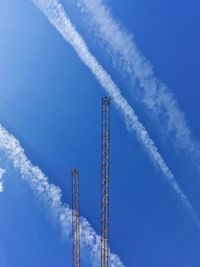 Low angle view of vapor trail against blue sky