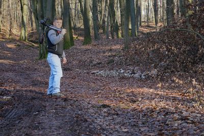 Portrait of man standing in forest