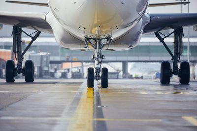 Close-up of airplane at airport runway