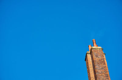 Low angle view of building against clear blue sky