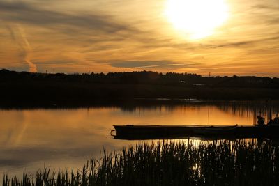 Scenic view of lake against sky during sunset