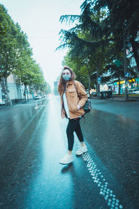 Full length of man walking on street in rain