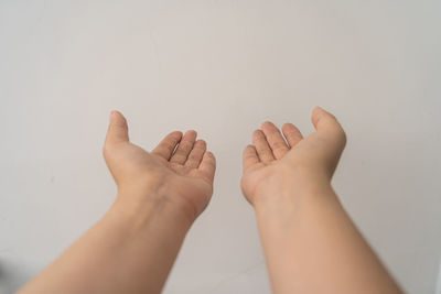 Low section of people against white wall