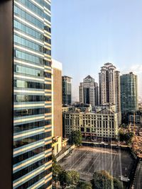 Modern buildings in city against clear sky