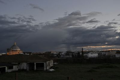 Buildings against cloudy sky