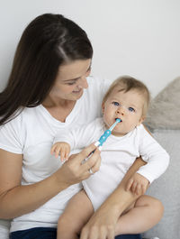 Mother playing with daughter at home