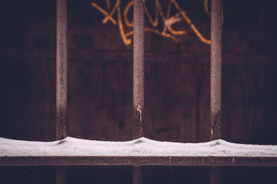 Close-up of snow on metal fence